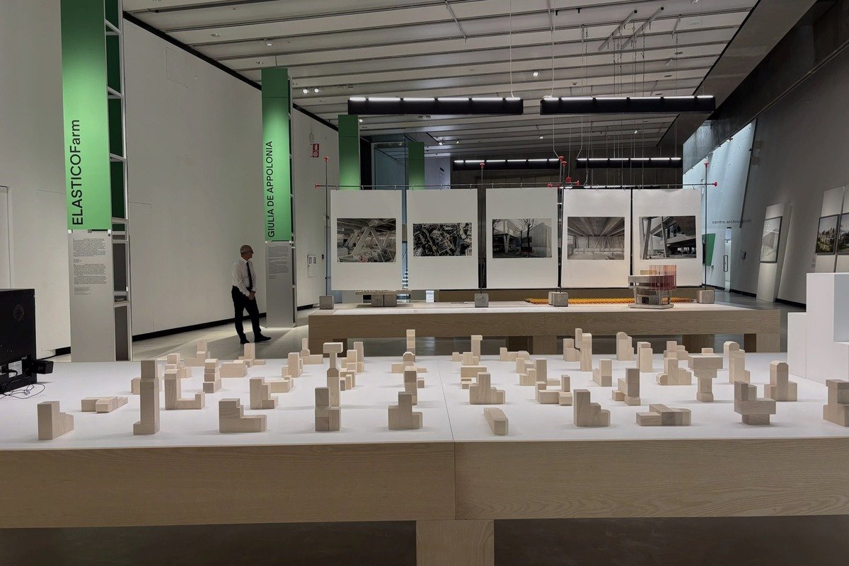 Maquette urbaine en bois sur table blanche dans une galerie d'architecture